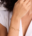 Dangling Dotted Bracelet in Gold